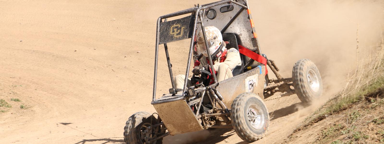 Car driving on dirt berm