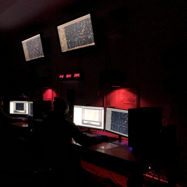 Our SBO Observing Team hard at work in front of the monitors with red lights.