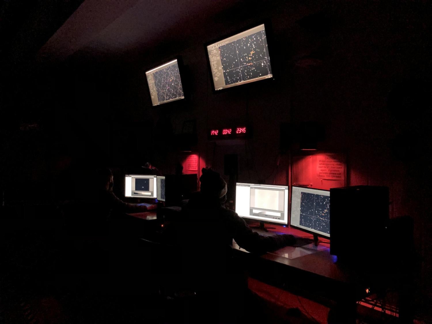 Our SBO Observing Team hard at work in front of the monitors with red lights.