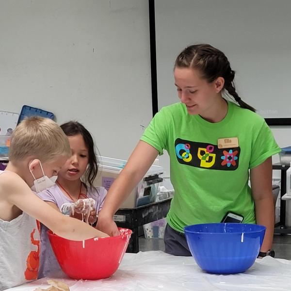 TA playing in gak with campers