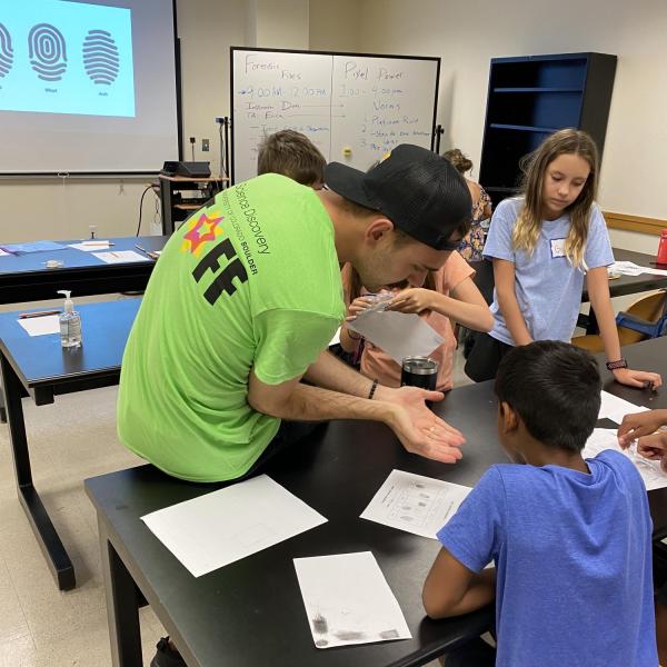 teacher showing student something in his hands