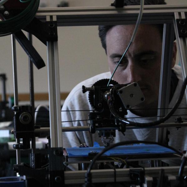 person watching 3D printer