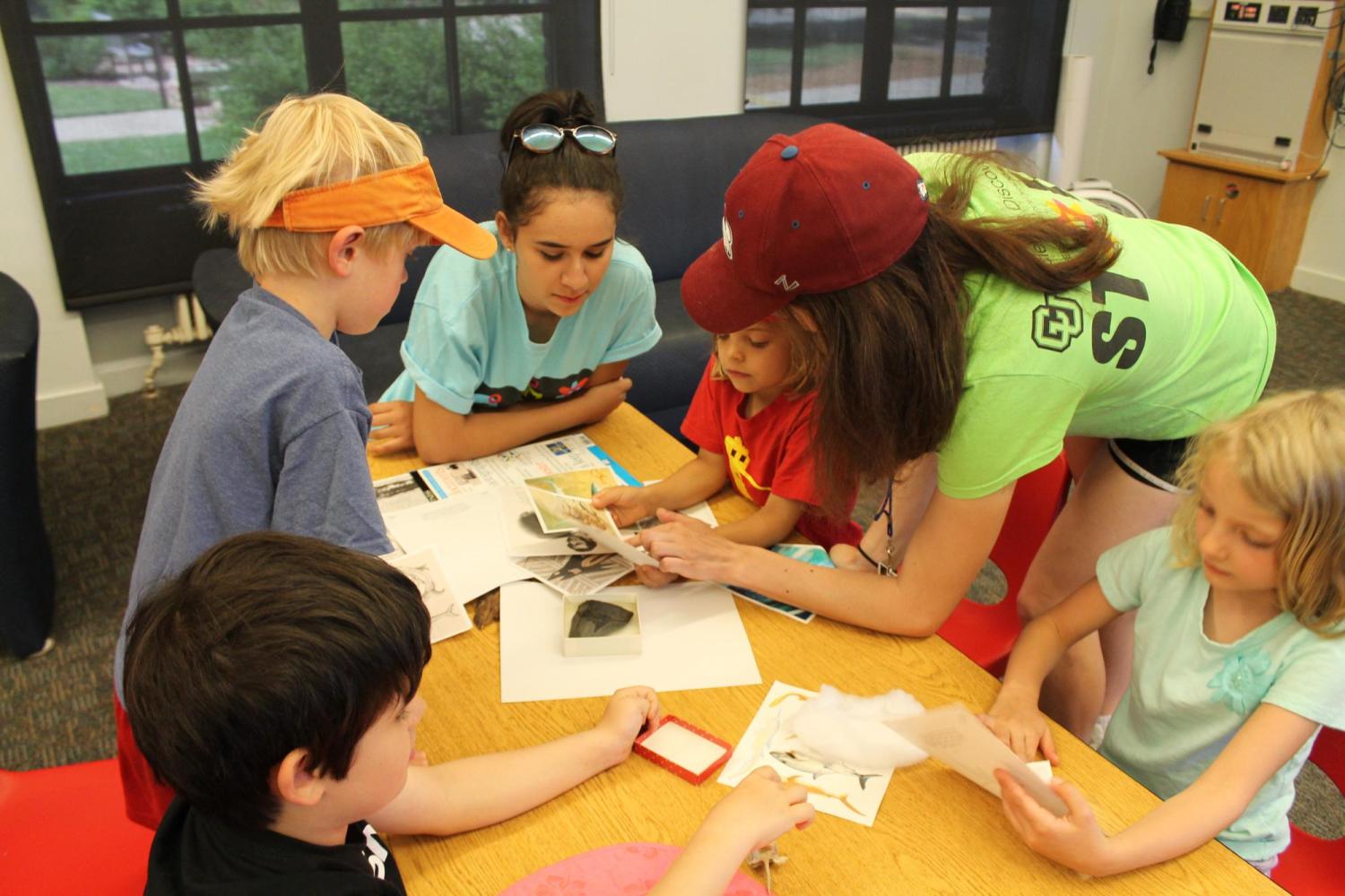 group of kids looking at specimens with teachers 