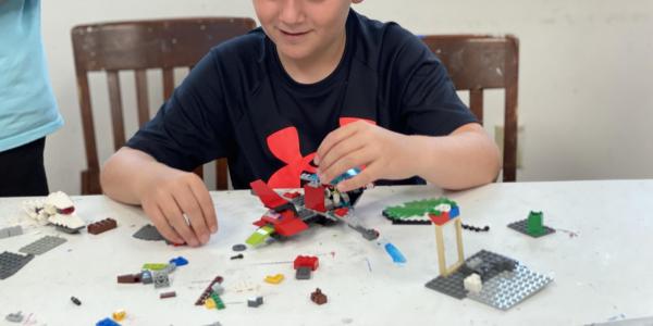 child building with lego