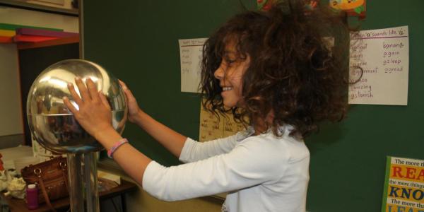 girl doing hair-raising experiment 