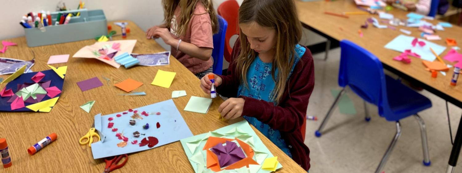 child doing nature craft