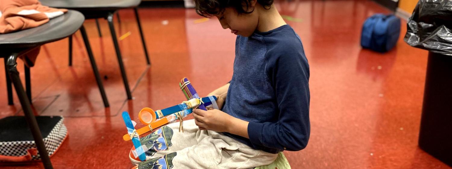 2 students making catapults