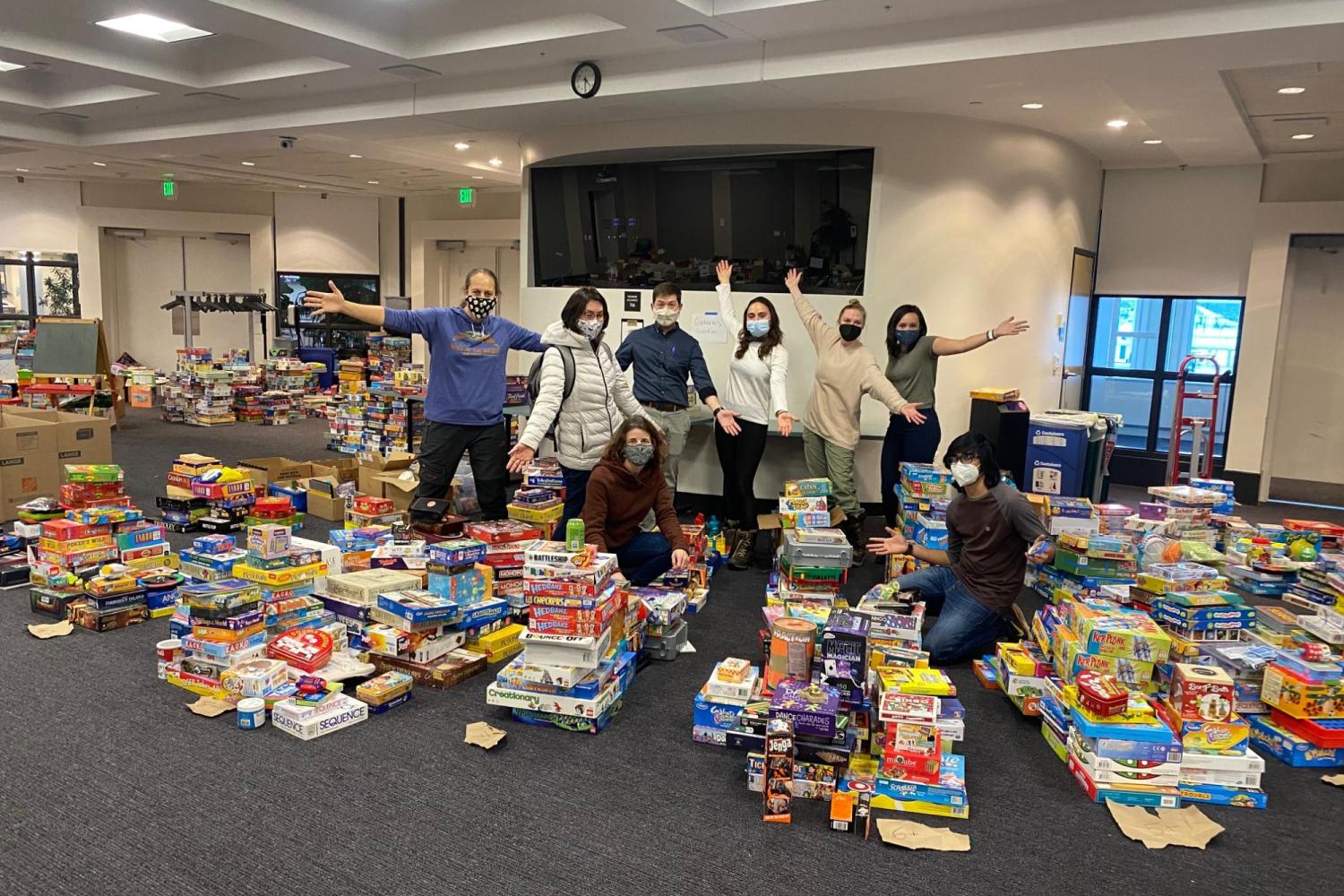 science discovery staff with toy drive donations 