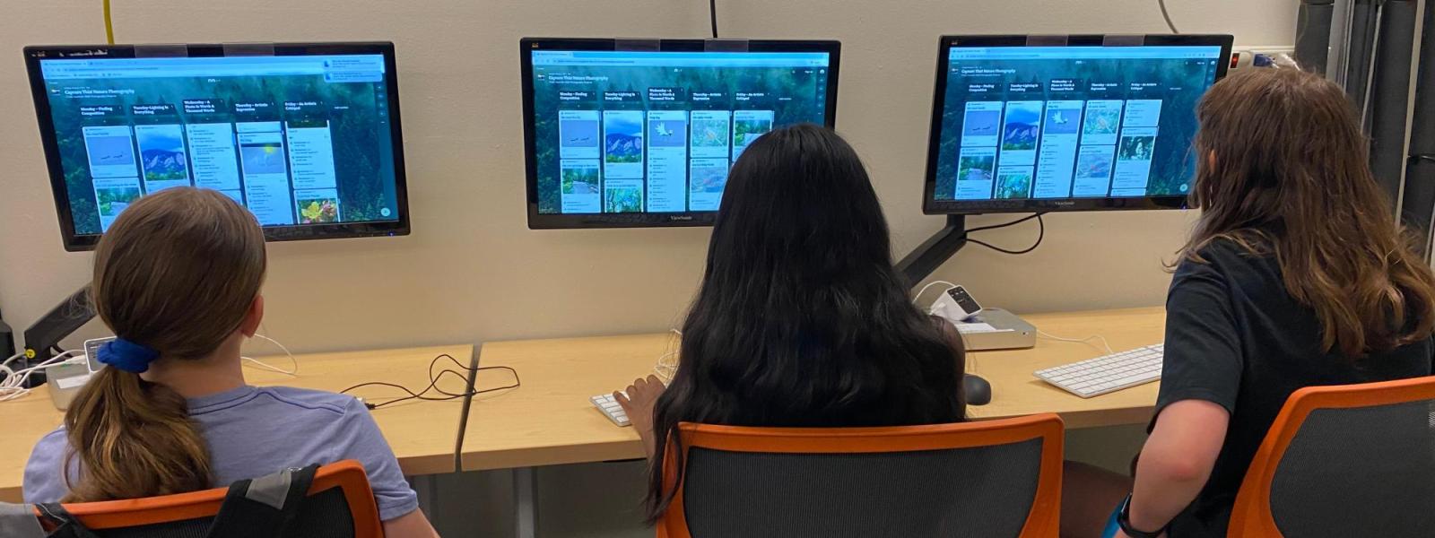 3 campers on computers 