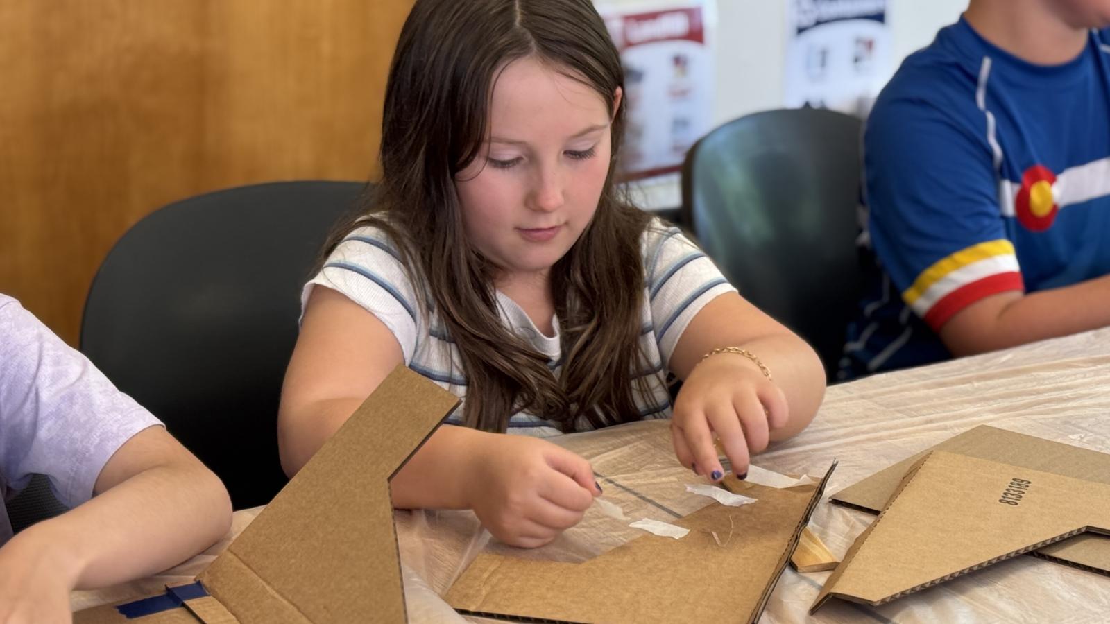 student building cardboard structure