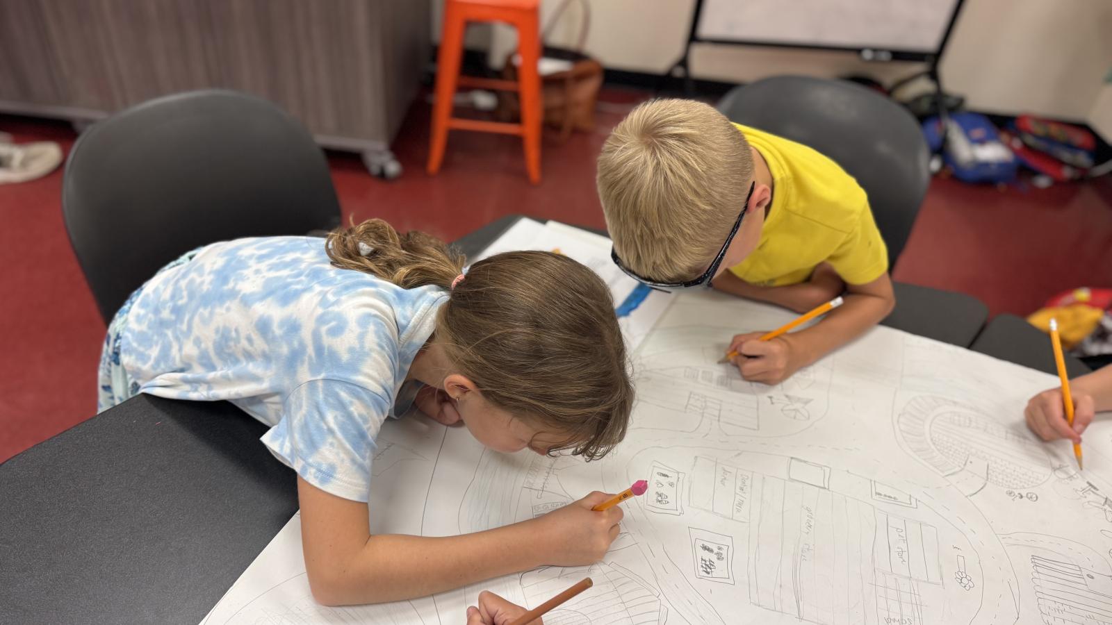 students working together on large scale drawing