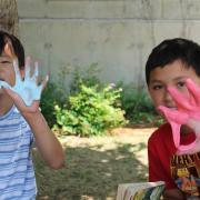2 boys showing slimy hands