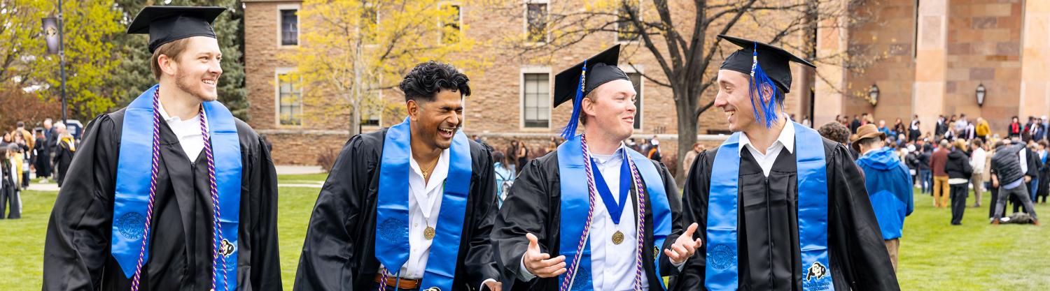 graduates walking and laughing