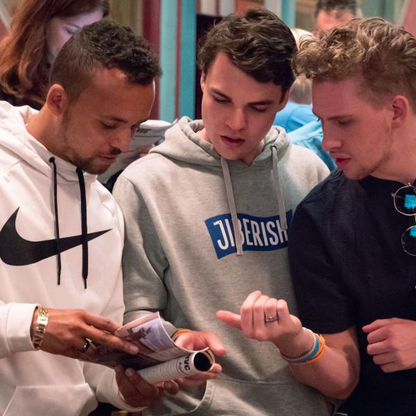 Students looking at brochure at New Venture Challenge