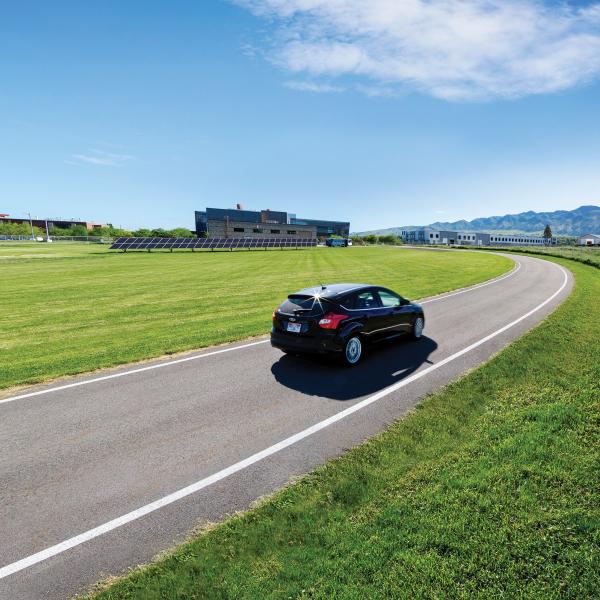 Electric car driving on a road in Boulder, CO
