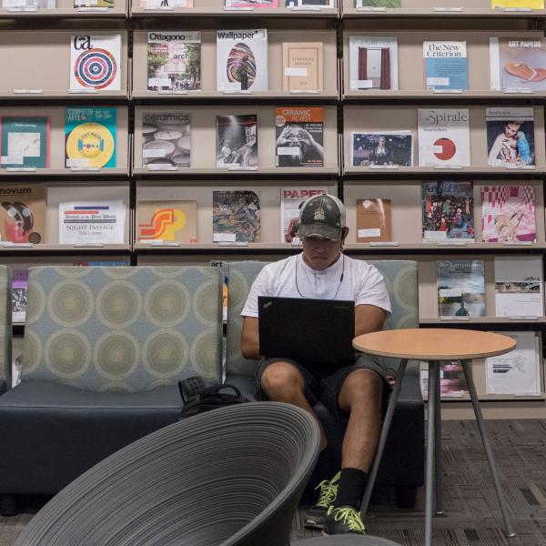 Student working on laptop in library