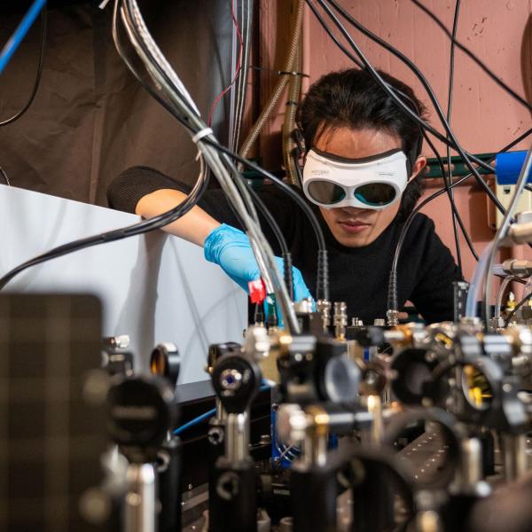 Qizhong Liang, a PhD candidate in JILA and the Department of Physics, demonstrates how the laser-based breathalyzer works, in the Ye lab at JILA.