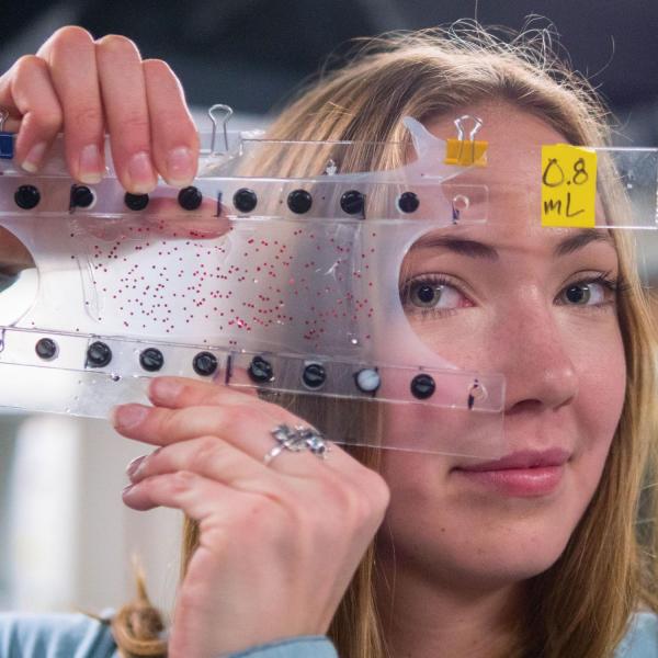 Student holding up soft, flexible device