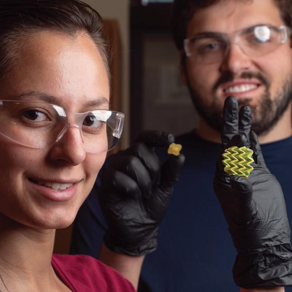 Researchers holding shape shifting material