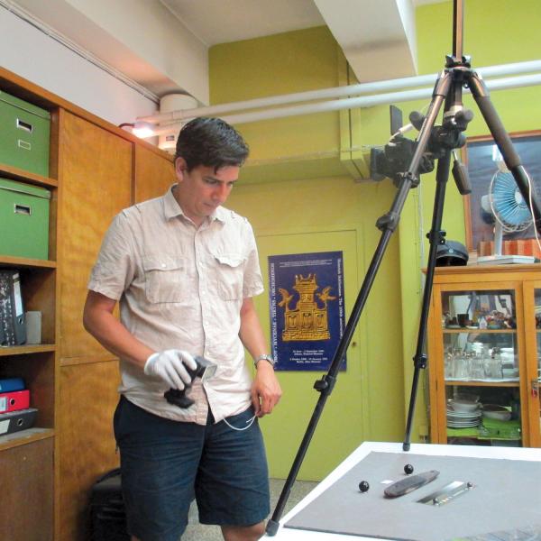 Dimitri Nakassis examining and photographing the pylos tablet