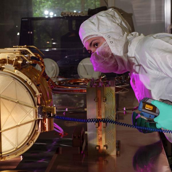 An engineer ground tests Europa Clipper’s dust analyzer
