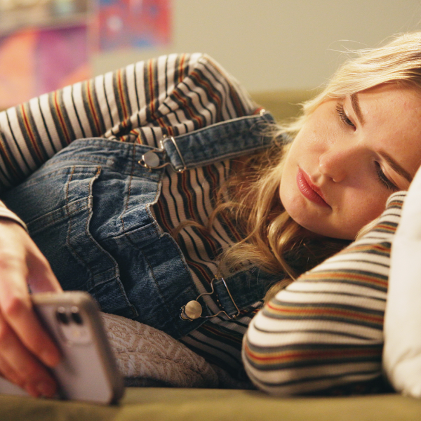 Teenage girl resting while checking her phone
