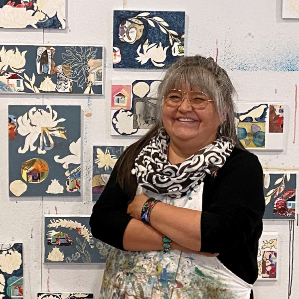 Melanie Yazzie with a collection of her prints