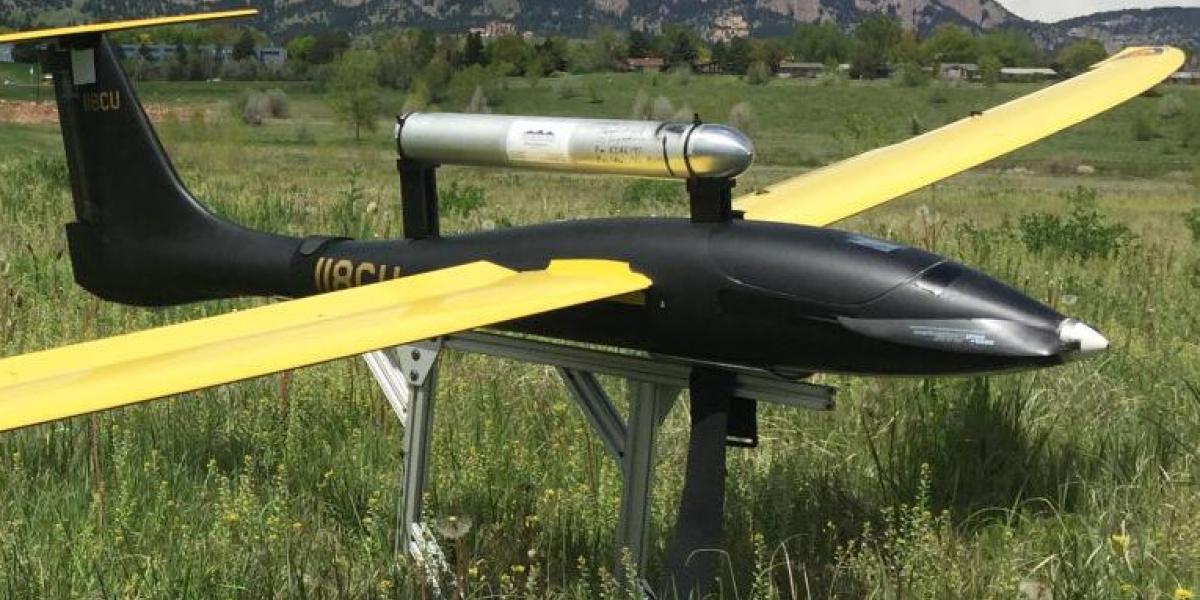 Unmanned flying vehicle parked in a field near Boulder