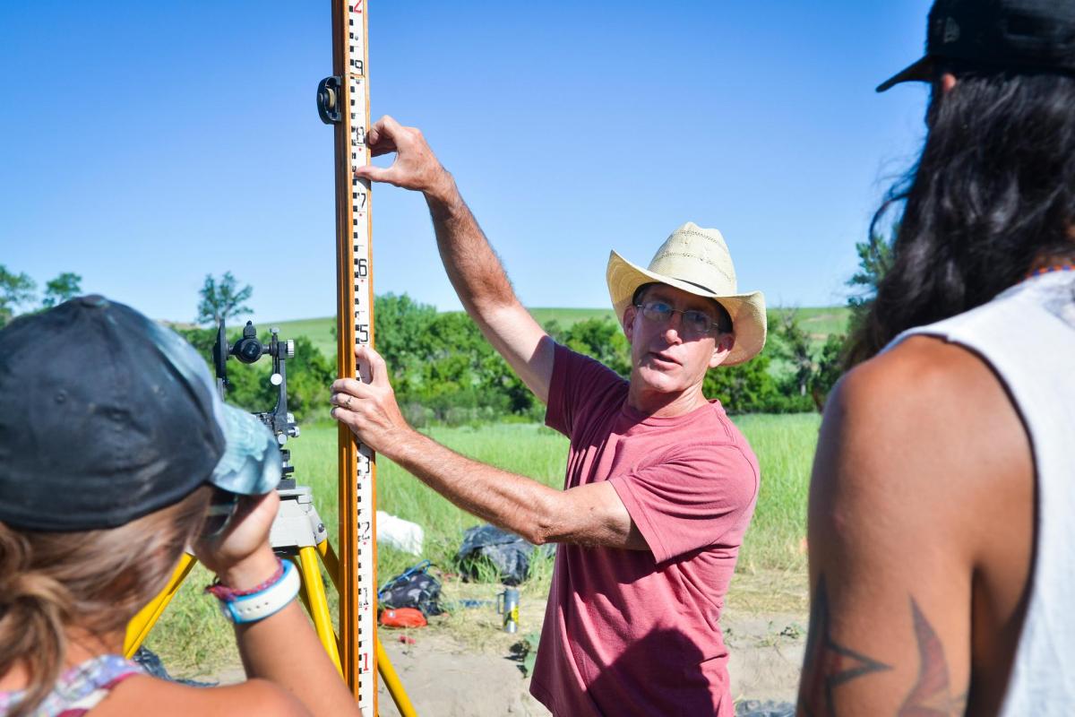 Archaeological field school professor with students