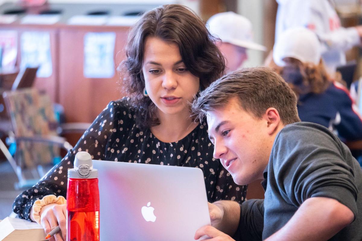 Students looking at laptop