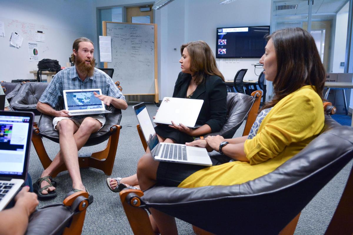 Professors in meeting with laptops
