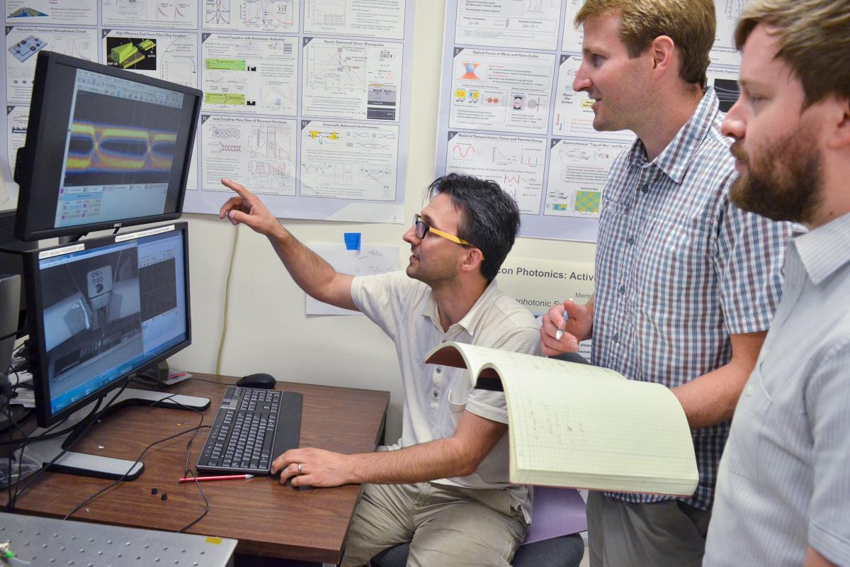 Students and faculty looking at computer screens in Engineering Lab