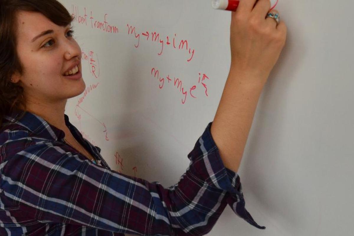 Student writing on whiteboard