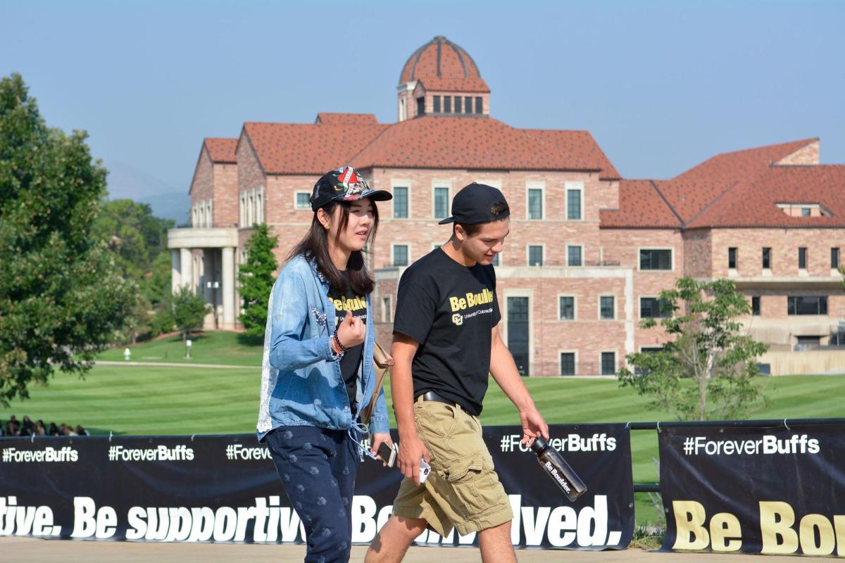 Students walking by Koelbel building
