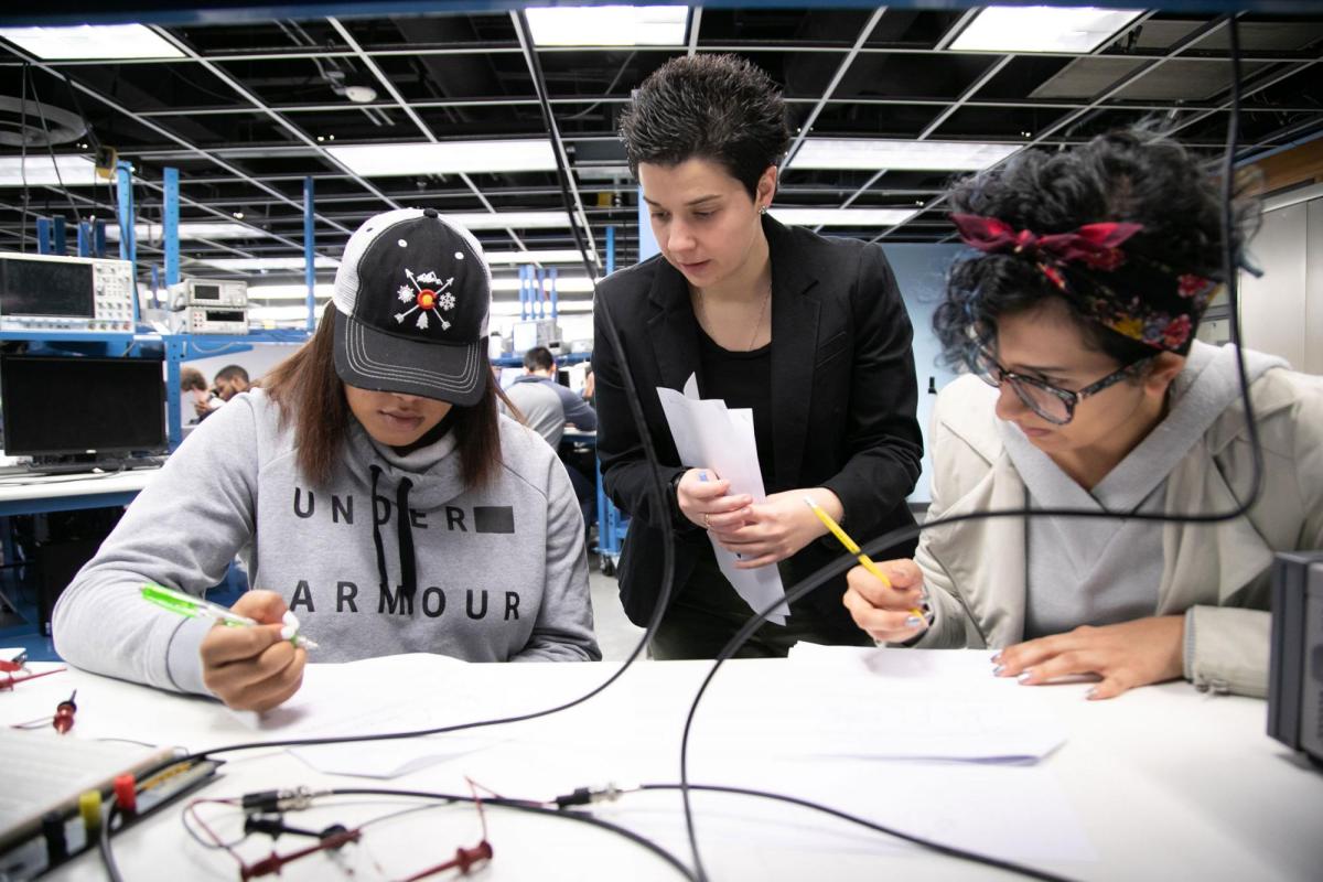 Engineering faculty and students working on project