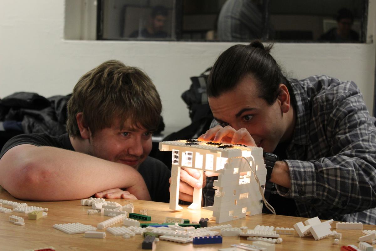 Two students work on a Lego lighting project during their architectural lighting design class