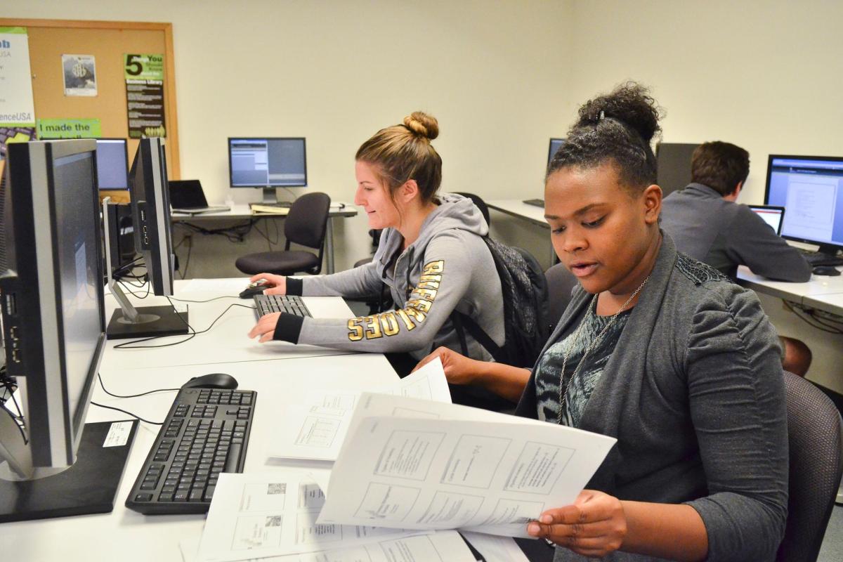 Students studying in Leeds School of Business library