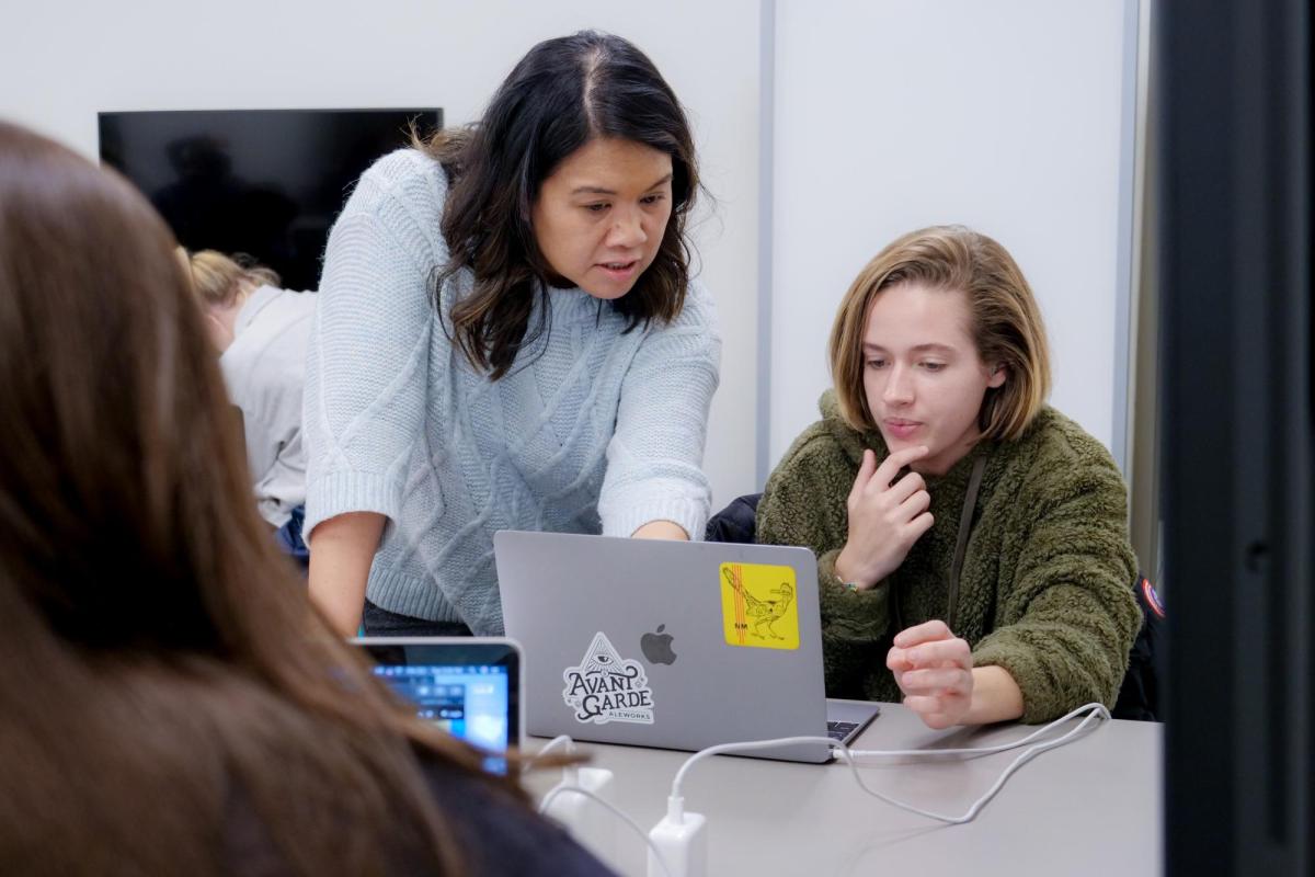 Professor works with student at a computer