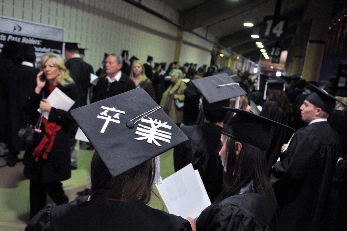 Graduates in subway corridor
