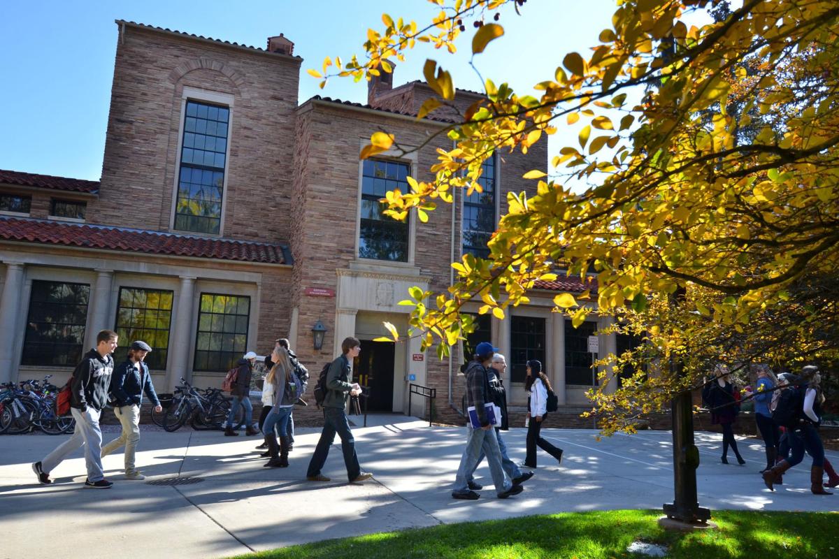 Students walking on campus in the fall
