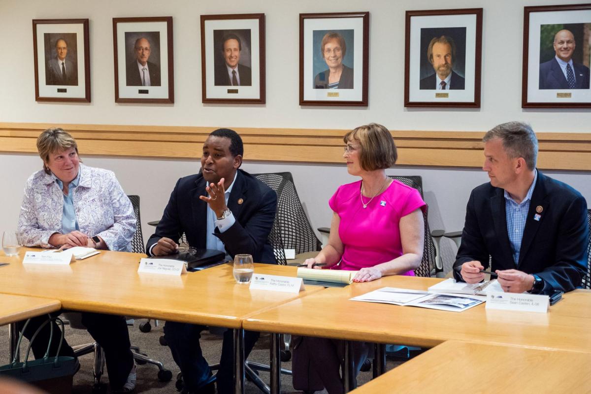 Congressional tour members at table