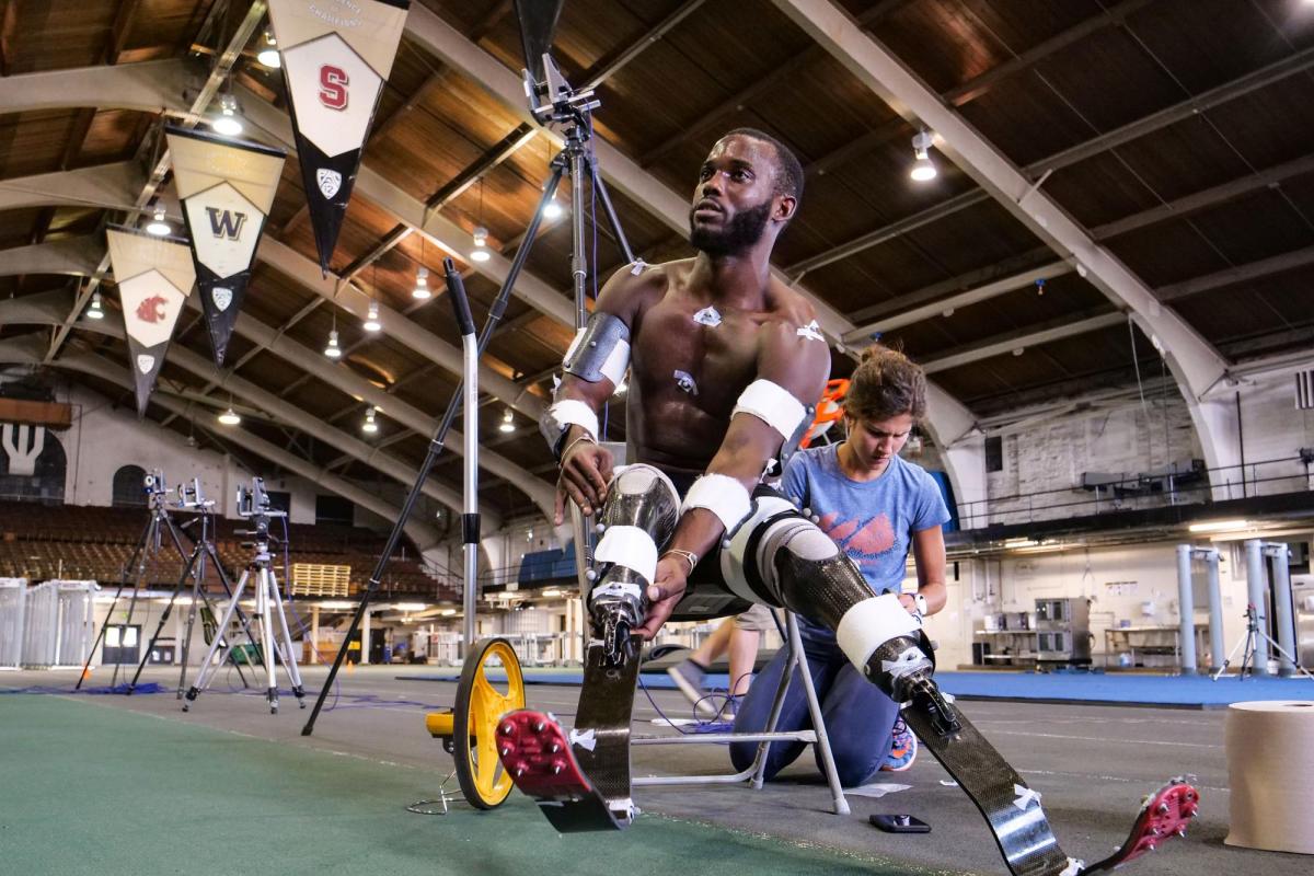Person in wheelchair with prosthetics