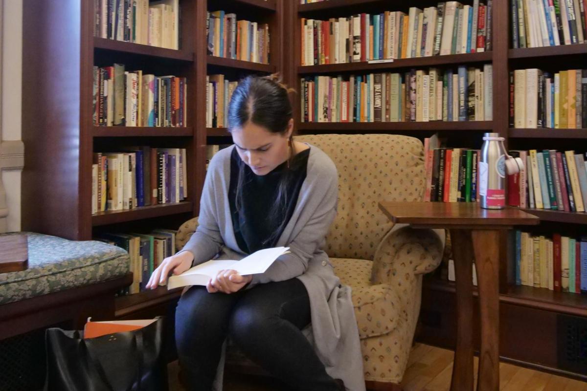 Student reading book in library