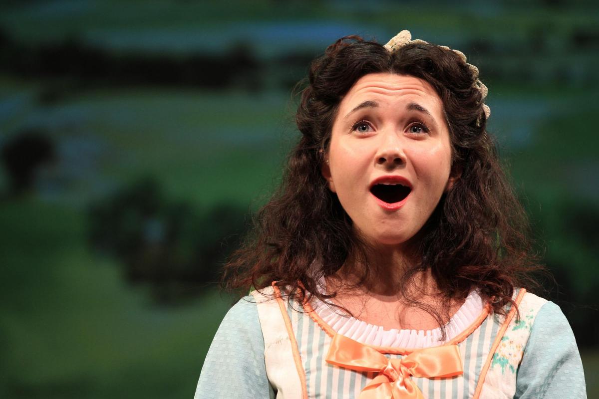 Student singing opera on stage