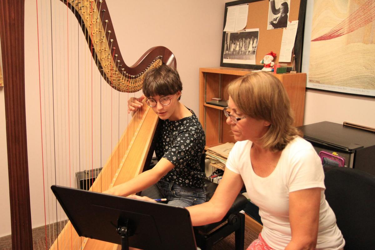 Faculty teaching harp student