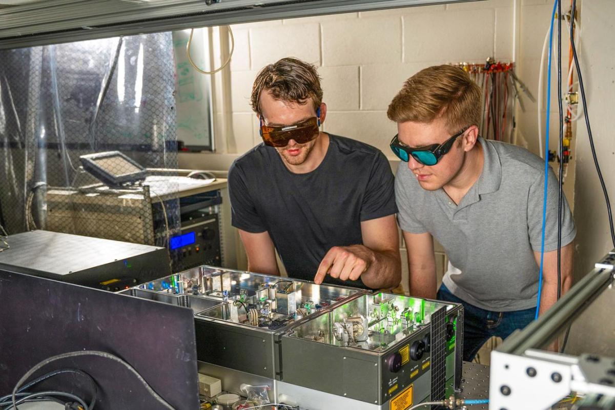Two students working at a laser table