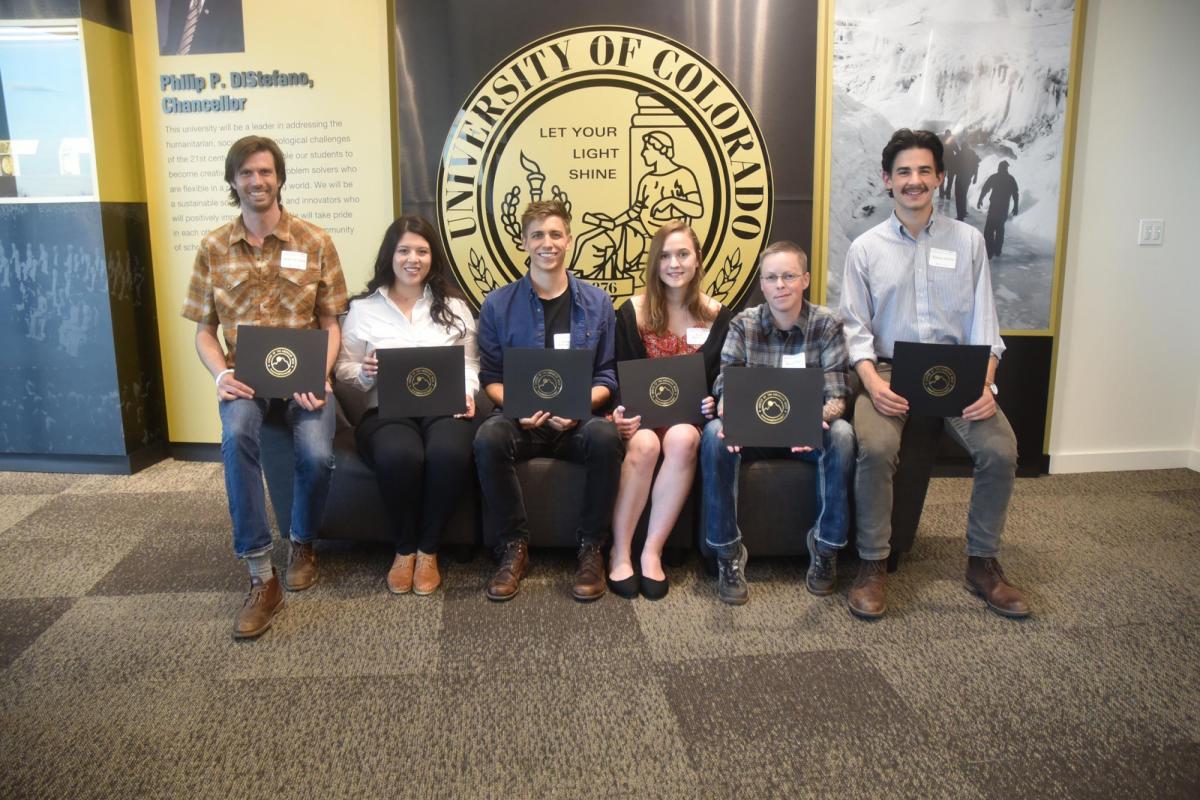 Students holding writing awards