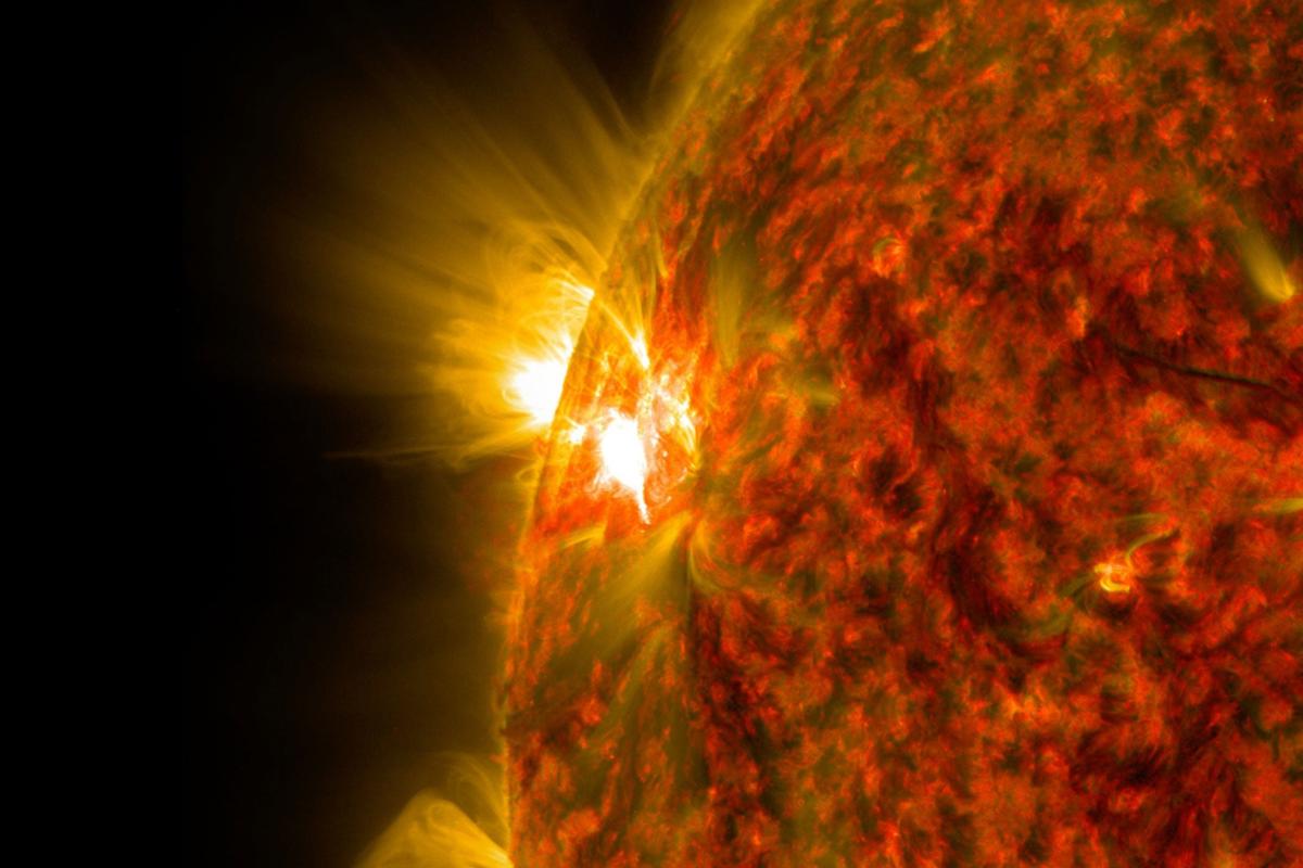 An active region on the sun emits a solar flare—a powerful burst of radiation