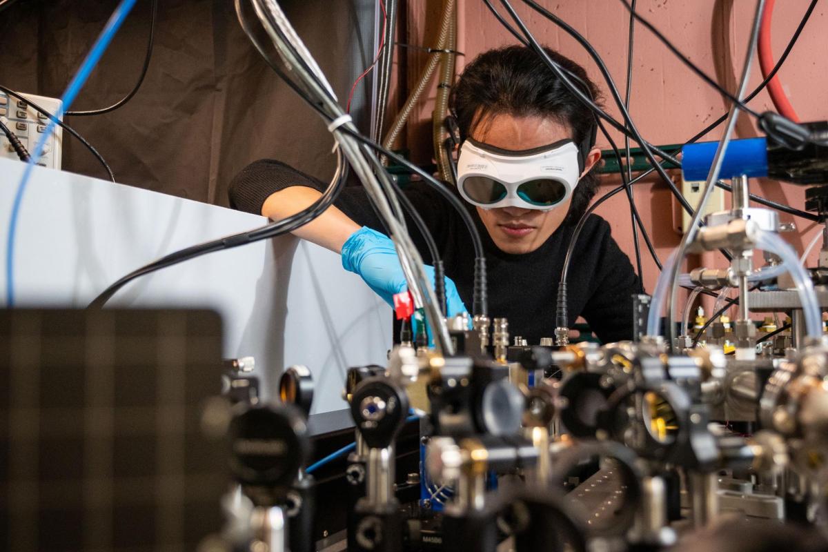 Qizhong Liang, a PhD candidate in JILA and the Department of Physics, demonstrates how the laser-based breathalyzer works, in the Ye lab at JILA.
