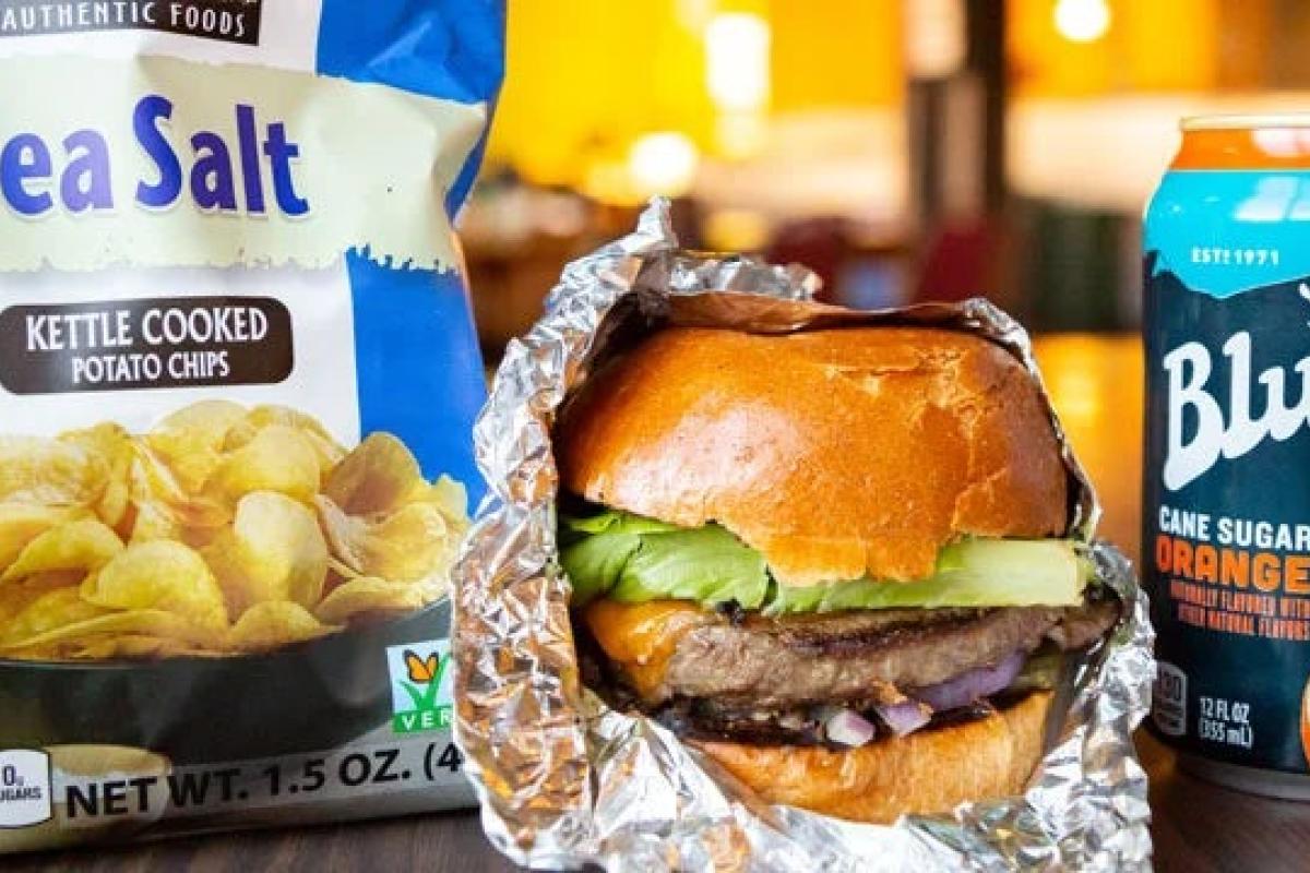 Takeout hamburger, chips and a drink